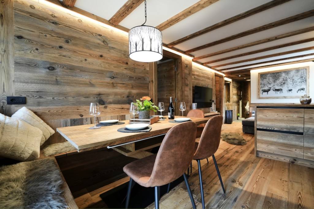 Zona pranzo con tavolo in legno e travi a vista