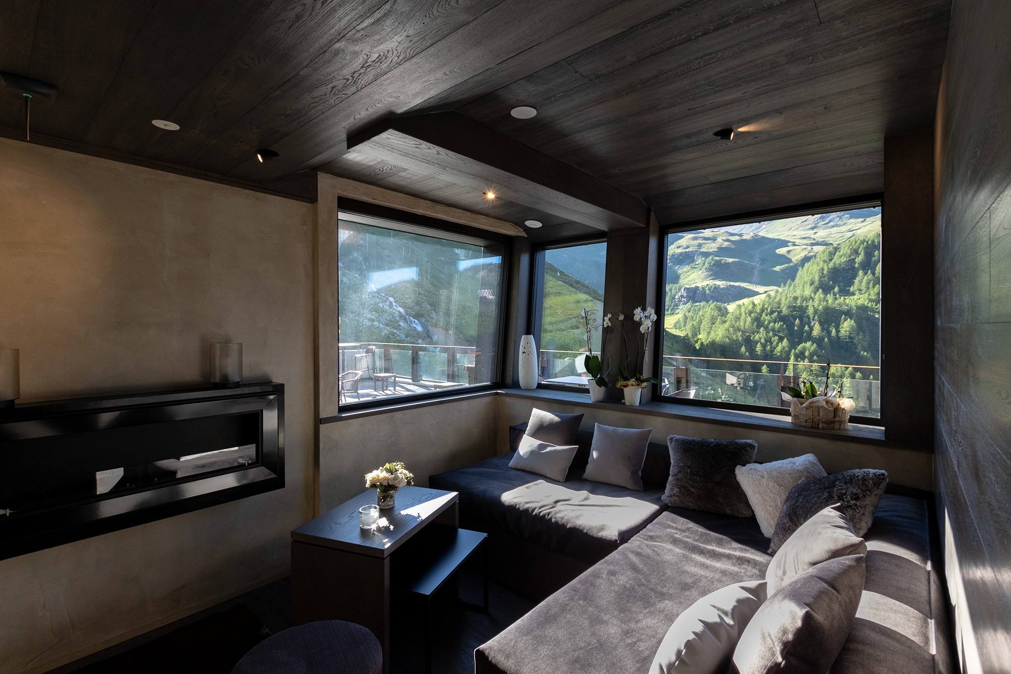 Lounge con divani e grandi vetrate sulle montagne