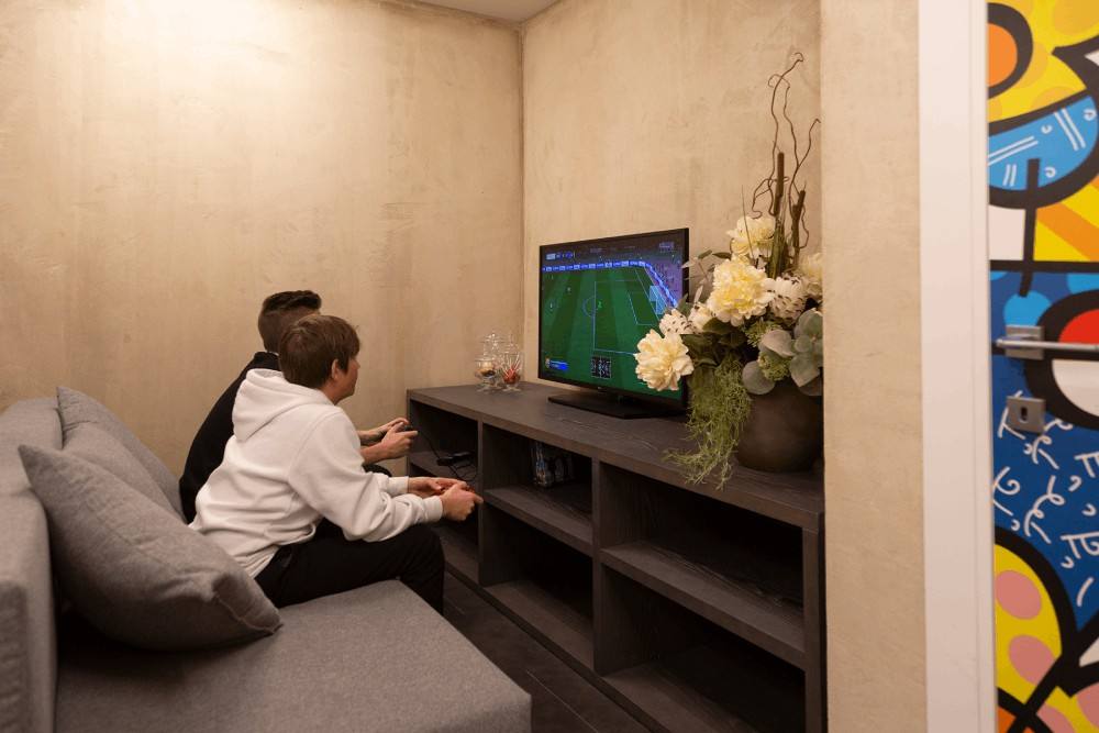 Ragazzi alla console nella sala giochi junior