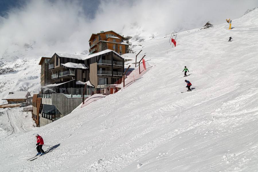 Sciatori sulla pista 3bis accanto al Bergman Mountain Hotel